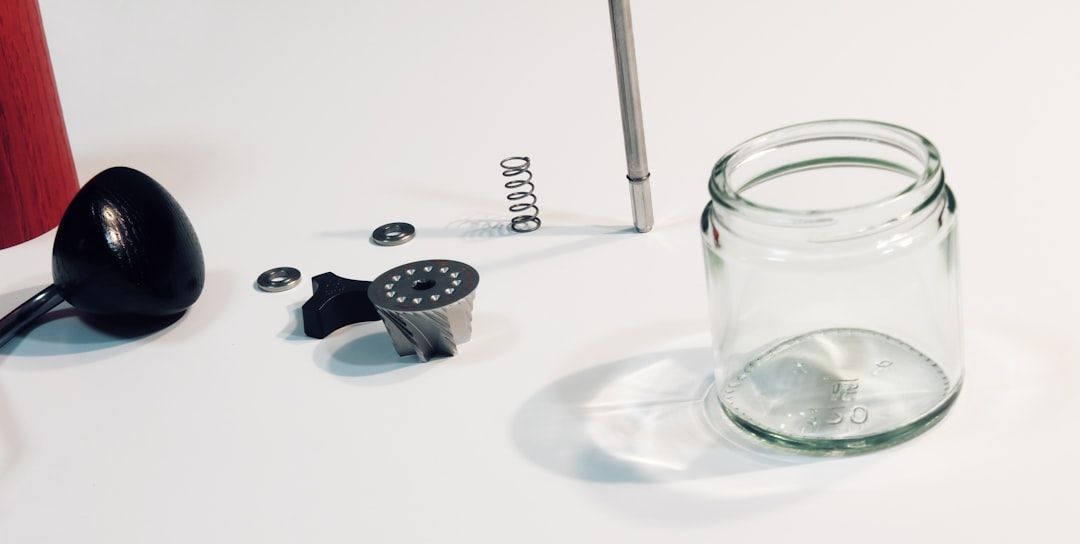silver and black dice on clear glass jar
