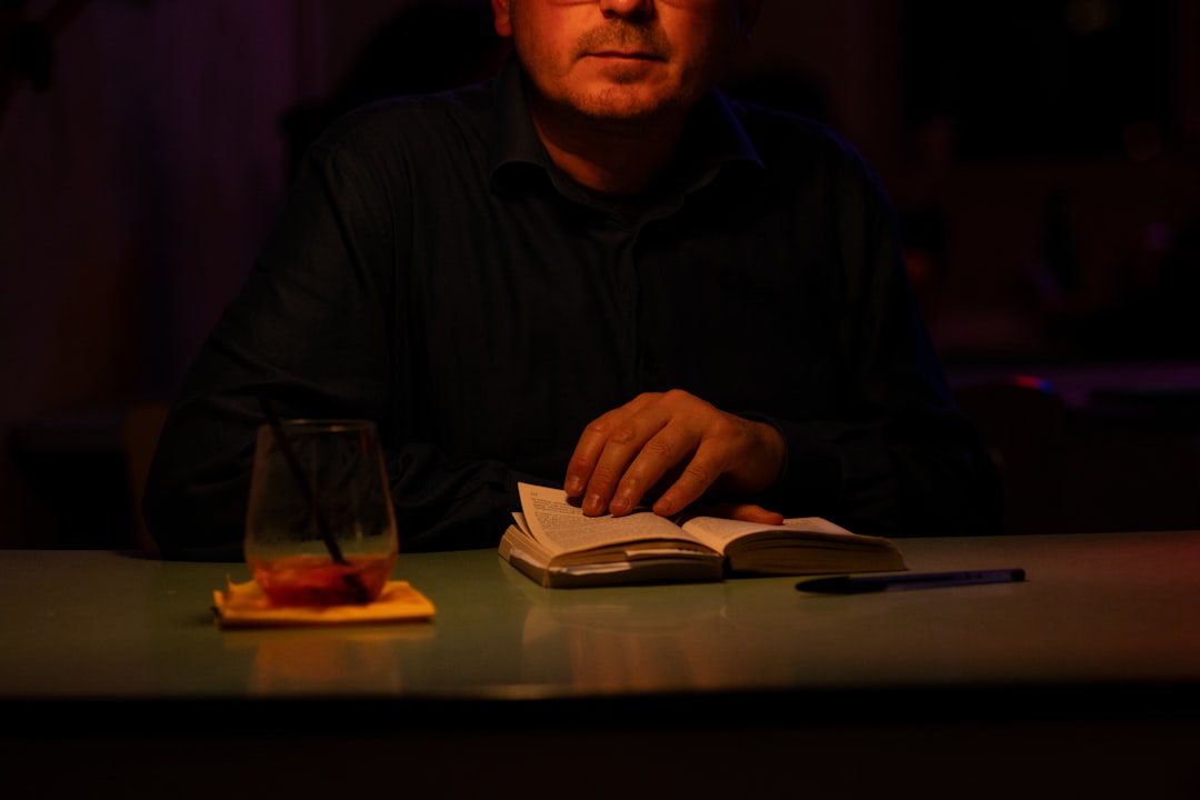 A man sitting at a table with a book