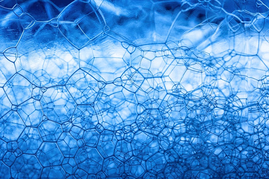 Detailed close-up of blue soap foam showcasing abstract geometric patterns and texture.