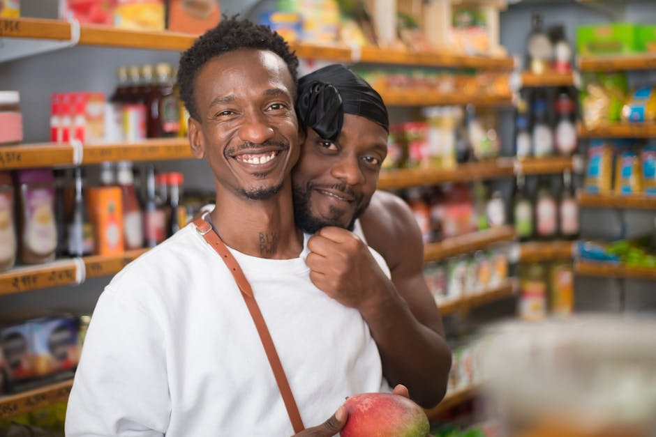 Smiling couple embracing and shopping in a grocery store, holding fresh produce.