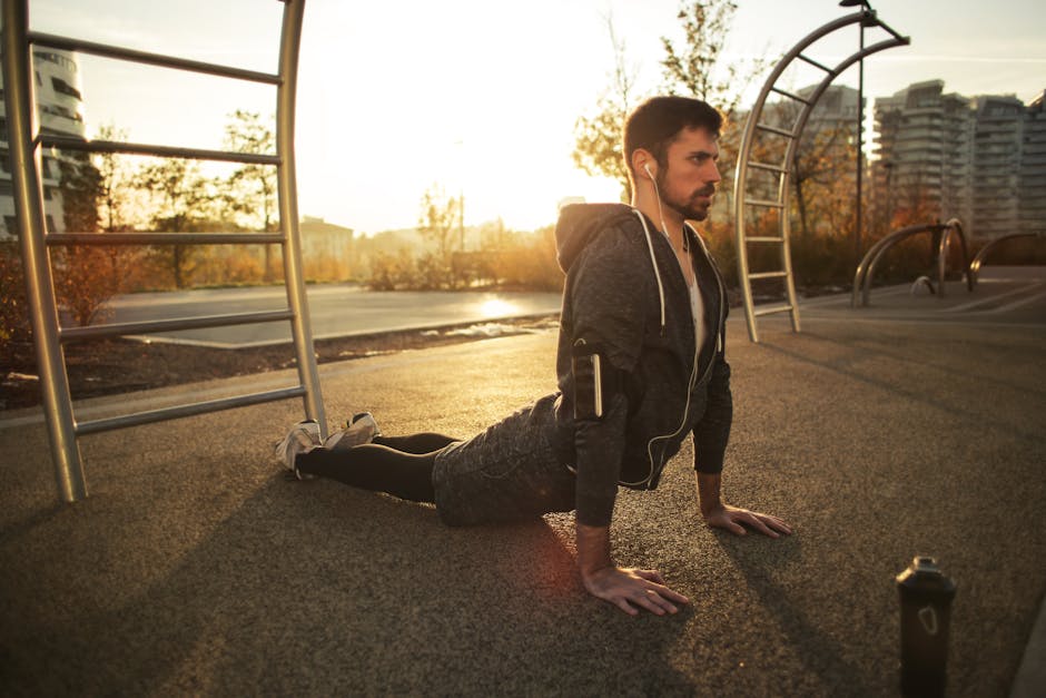 A man doing yoga in a park during sunrise, highlighting fitness and a healthy lifestyle.