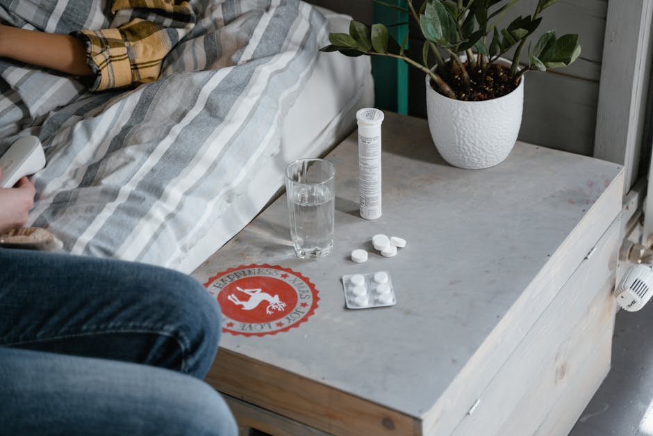 Cozy bedside setup with medication and glass of water, suggesting home healthcare.