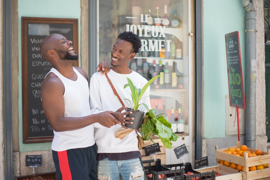Happy couple shopping for plants and vegetables at an outdoor market in Lisbon, Portugal.