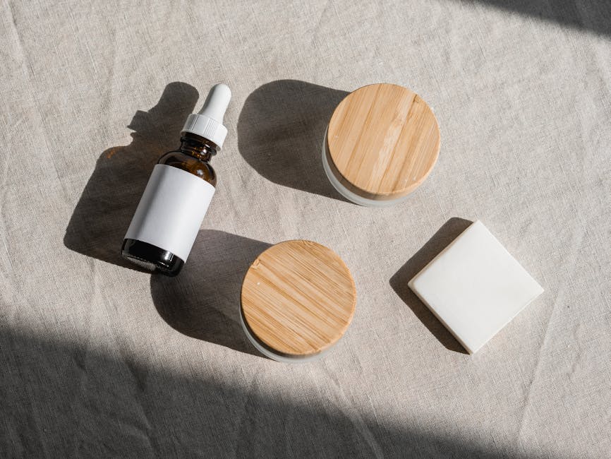 Flat lay of natural skincare products with wooden lids on a linen fabric background, perfect for eco-friendly branding.