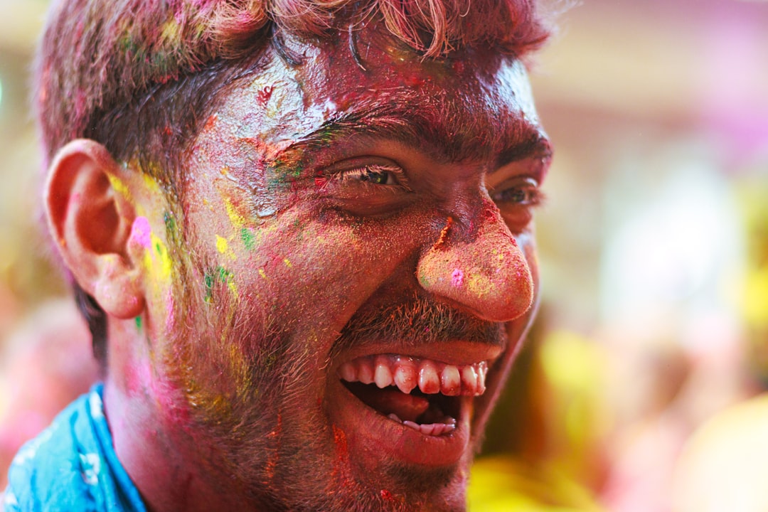 a man with his face smeared with colored powder
