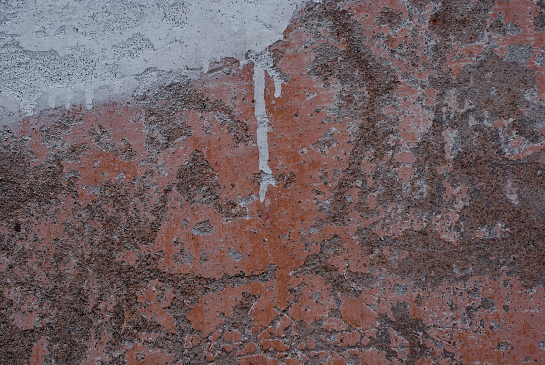 a close up of a stone wall with ice on it