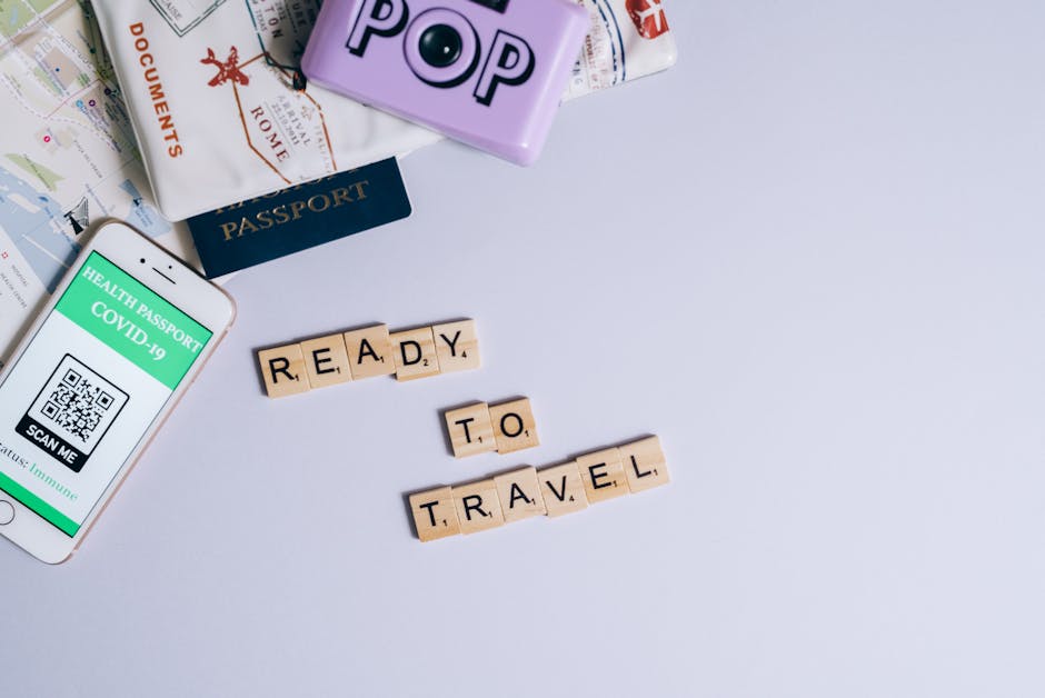 Travel essentials including passport, map, and health passport app ready for post-pandemic journeys.