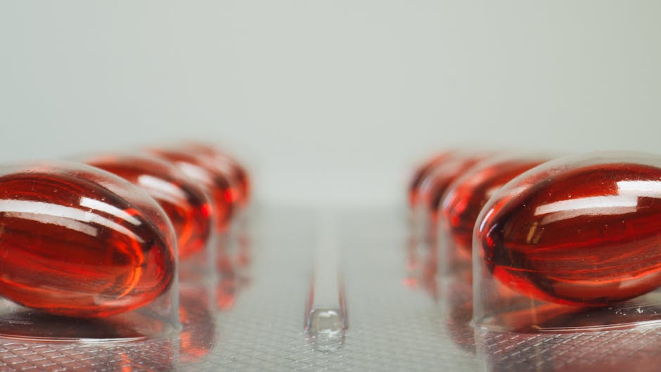 Macro shot of red capsules in a blister pack with selective focus on medicinal pills.