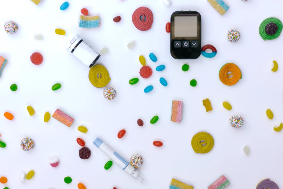 Scattered candies with glucose meter and syringe indicating diabetes and healthcare.