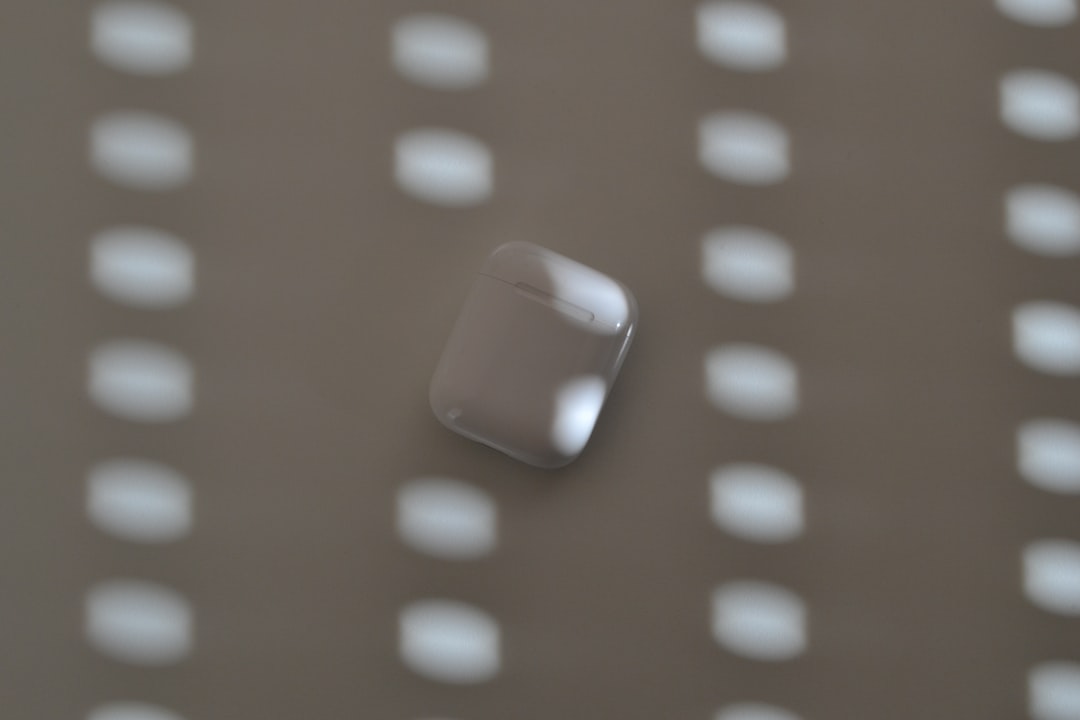 Airpods case against a patterned background.